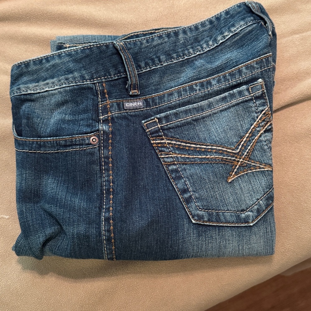 Women’s Cinch Dark Blue Denim with tan/brown Stitching, size 30/9R.